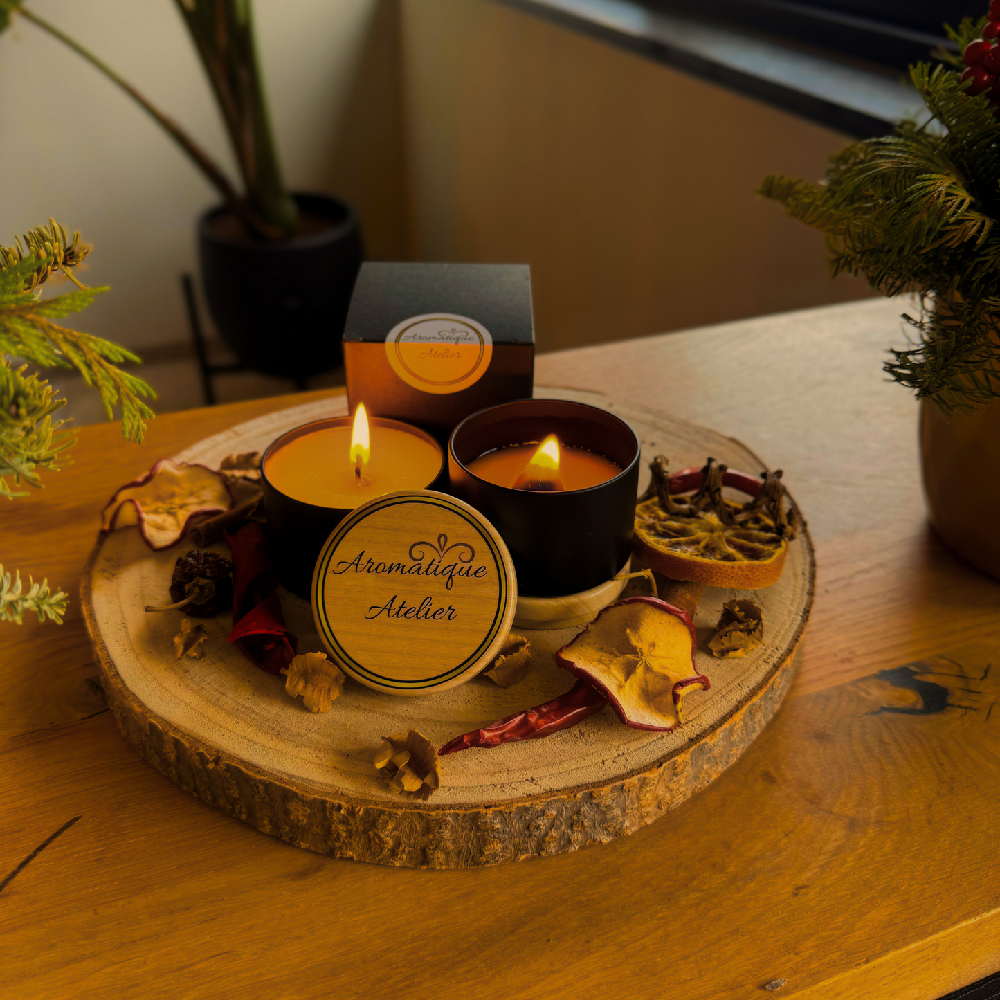 3X Classic 23+H designer inspired scent candle display on wooden tray with decorative elements.