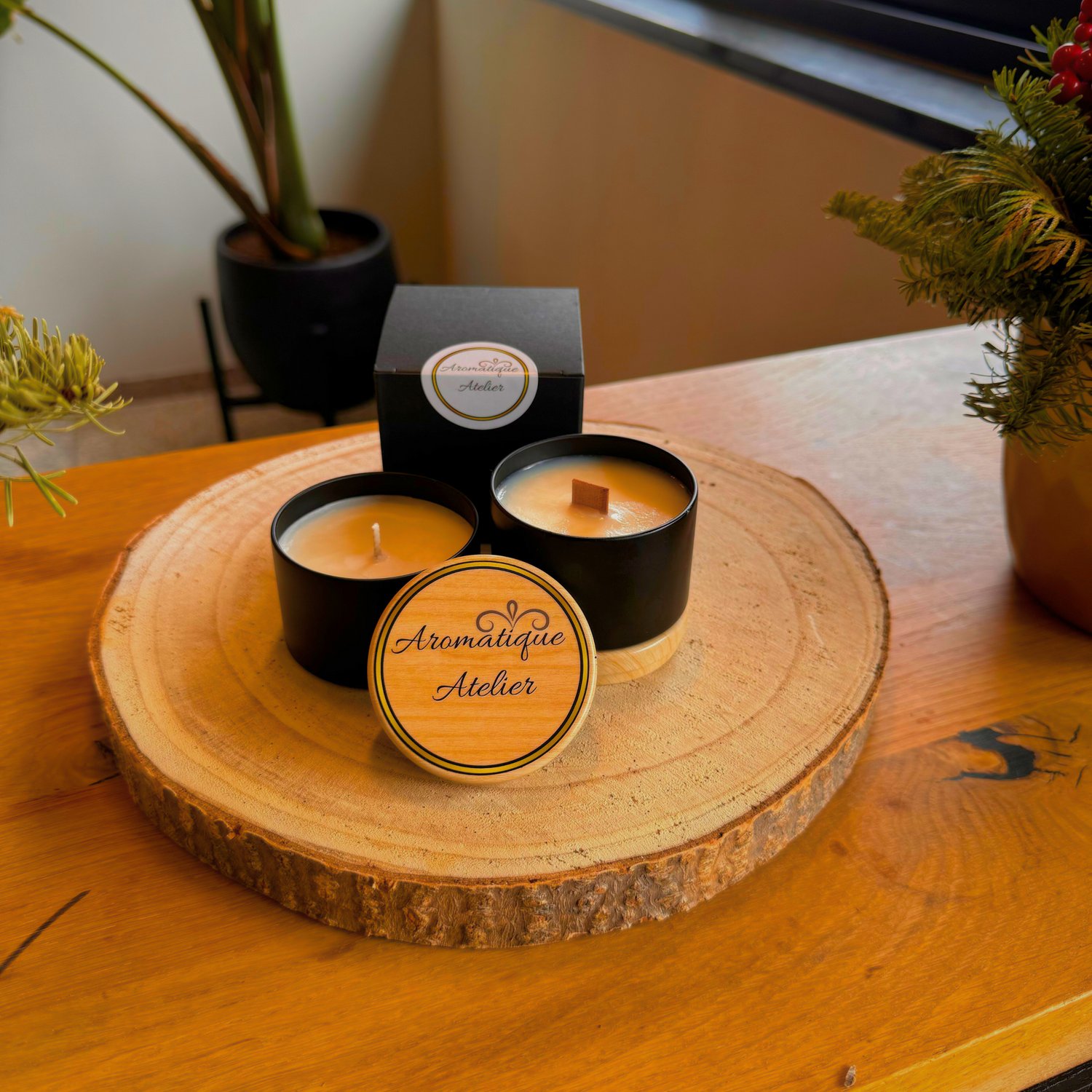 23+H Classic Candle styled on a wooden slab with elegant black packaging.