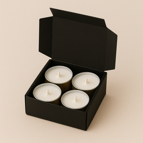 Box of four white scented tea light candles in black packaging